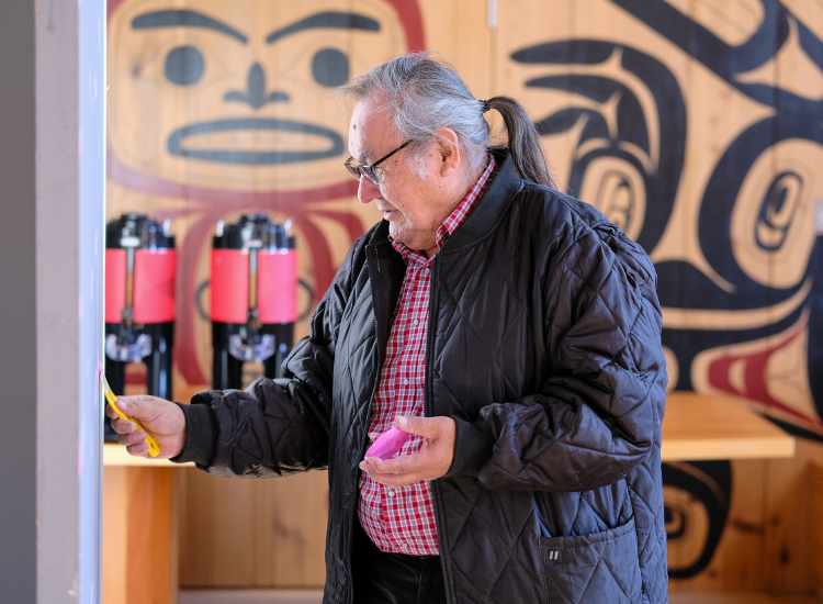 Dene'Tum prepares a wall for the student art exhibit.