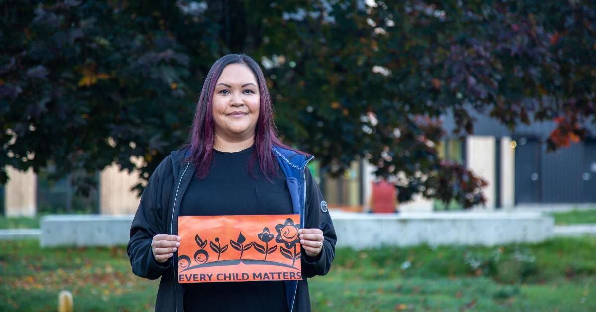 Artist Frances Campbell holds up design for Orange Shirt Day