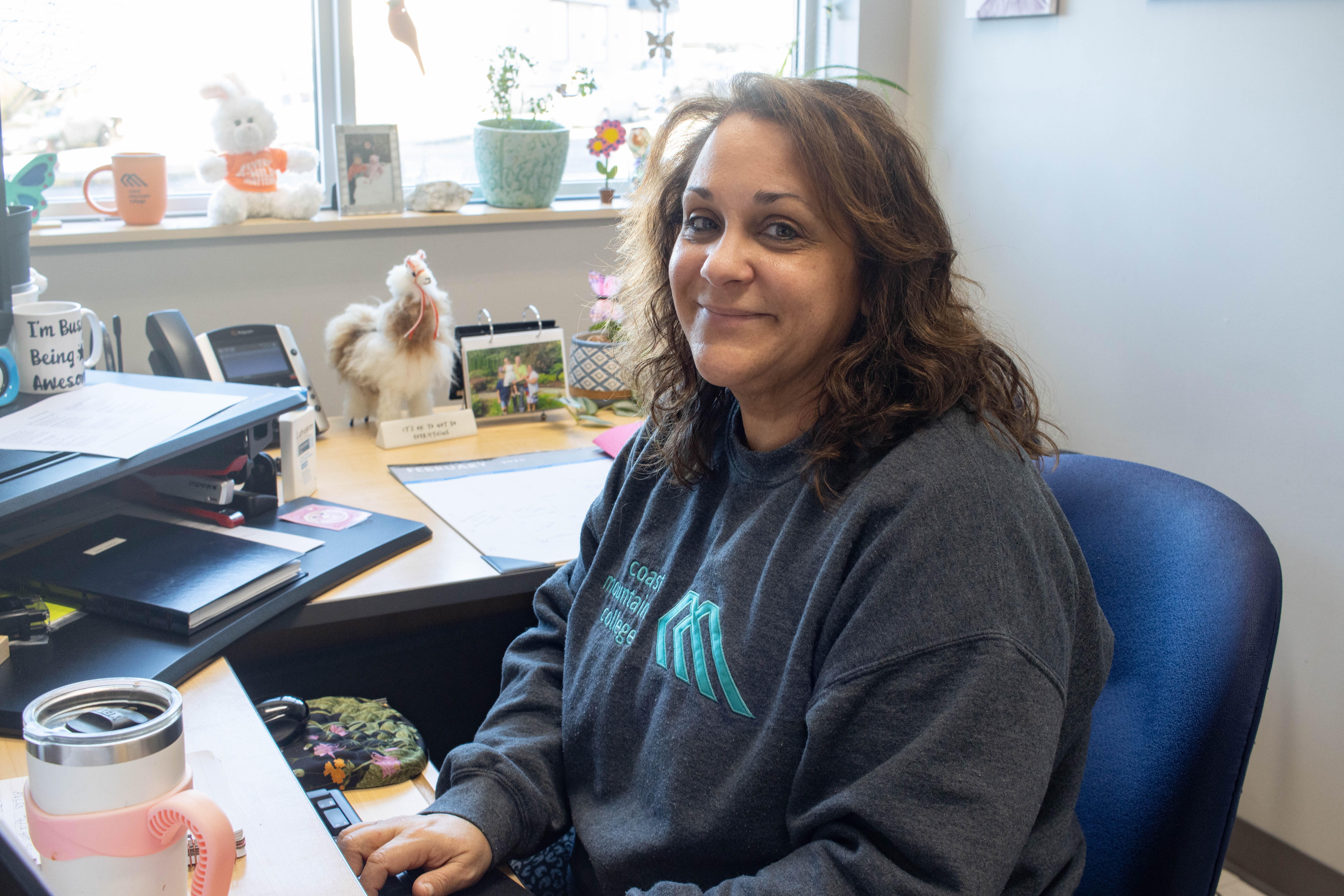 Sandy Kaardal sitting by her desk